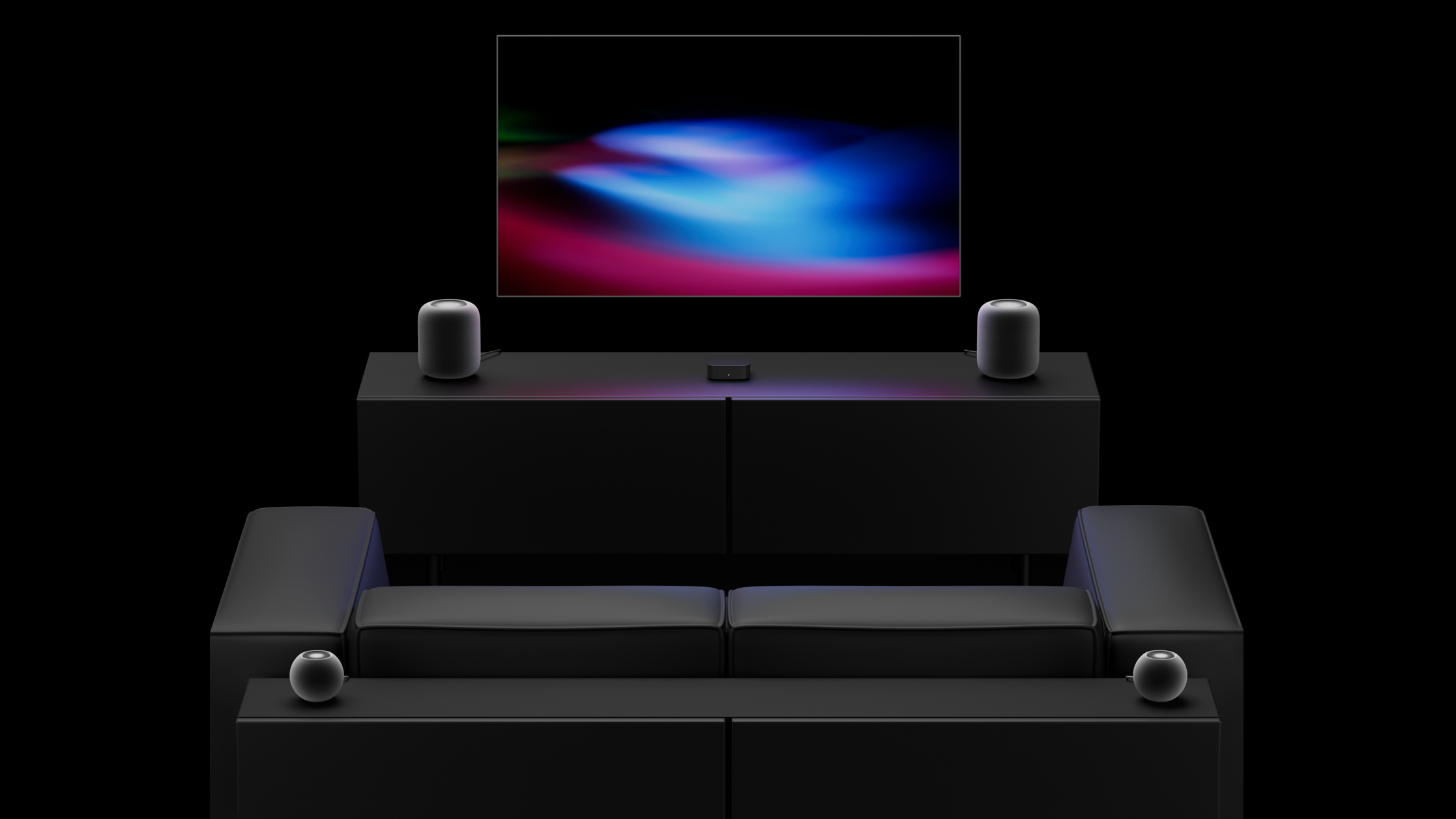 Televize s Apple TV a čtyřmi reproduktory HomePod v obývacím pokoji